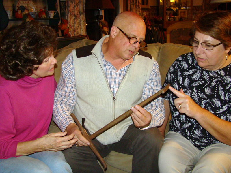 From left: Carolyn Baltes, John Bottero, and Cally Bartholomae discuss an unusual mystery antique that will be presented at a Nov. 11 event in Nobleboro.