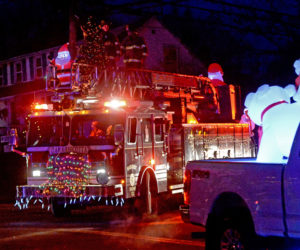 Polar bears watch the Damariscotta Fire Department ladder truck during the Villages of Light parade. (Paula Roberts photo)