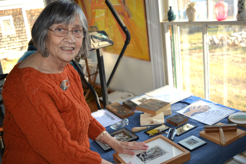 Sally DeLorme Pedrick, who creates woodcuts in addition to painting and blowing glass, talks about her woodcut process at a Dec. 3 opening reception at her home gallery, The Library Art Studio in Round Pond. (Christine LaPado-Breglia photo)