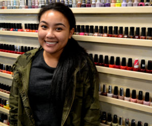 Mainely Nails owner Mary Huynh stands in front of a rack of nail polish in the salon's new location at 523 Main St. in Damariscotta. (Maia Zewert photo)