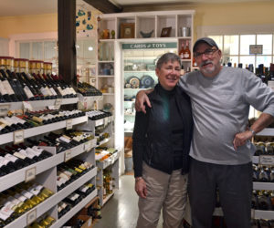 Weatherbird owners Debra and Scott Devlin stand in the specialty food store's wine section. The Devlins recently purchased the food and kitchenware shop from Wayne and Joanne Moore, who will continue to own the clothing store on Main Street now known as W Boutique. (Maia Zewert photo)