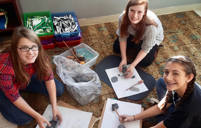 From left: Whitefield Elementary School seventh-graders Emmalee Donahue-Ripley, Hannah Jackson, and Jenna Perkins work with clay in Hollie Hilton's art class. (Photo courtesy Hollie Hilton)