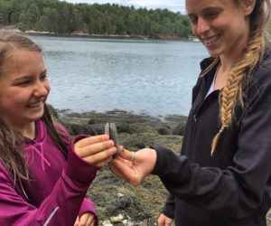 Mira Hartman, 10, of Edgecomb, and instructor Becca Slack search for gratitude rocks on the Sheepscot River during Hearty Roots' pilot summer program. (Photo courtesy Haley Bezon)