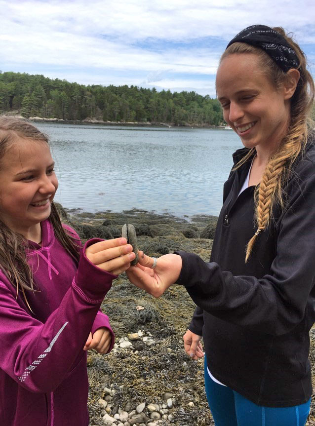 Mira Hartman, 10, of Edgecomb, and instructor Becca Slack search for gratitude rocks on the Sheepscot River during Hearty Roots' pilot summer program. (Photo courtesy Haley Bezon)