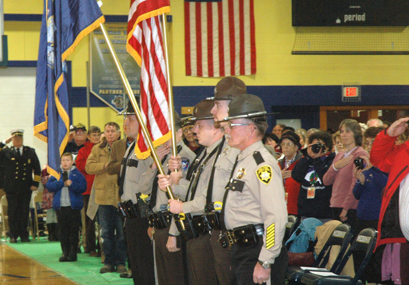 Knox and Lincoln County sheriff's deputies stand at attention as Medomak Valley High School students perform the national anthem. (Alexander Violo photo)