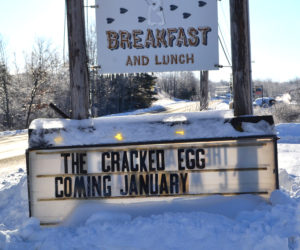 A sign along Gardiner Road in Wiscasset announces the impending arrival of The Cracked Egg. The Hunters Breakfast sign will soon come down and a permanent sign for The Cracked Egg will go up in its place. (Charlotte Boynton photo)