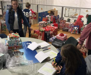 Youth help organize gifts.