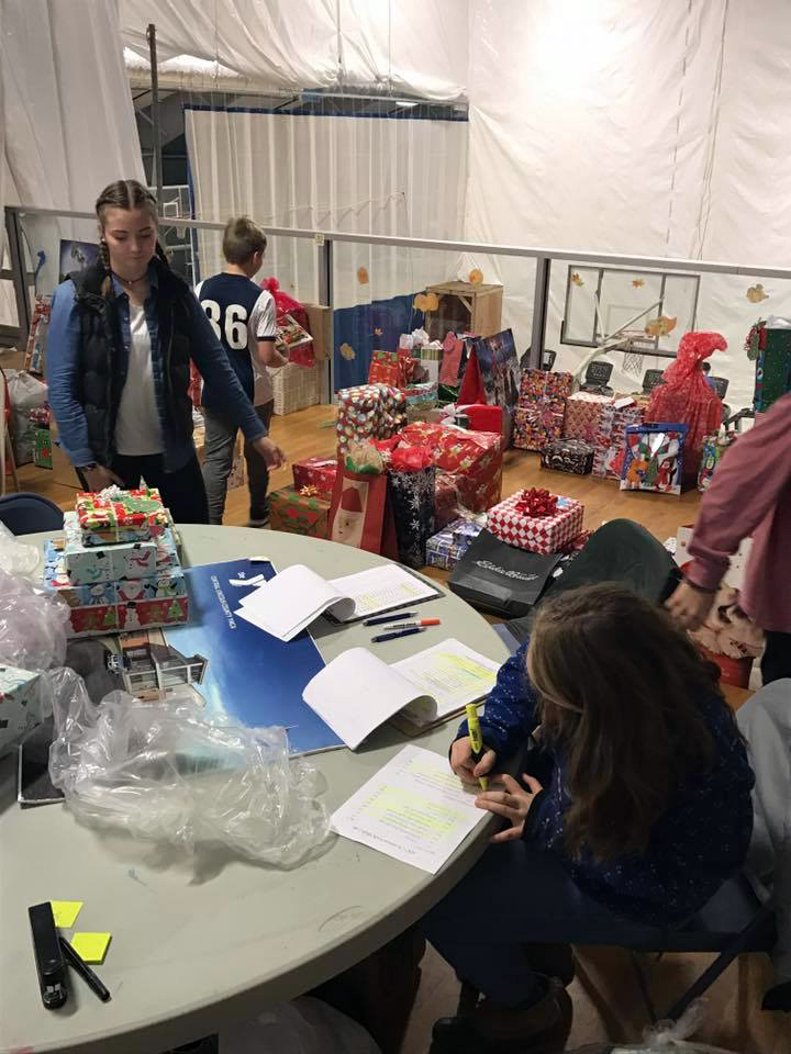 Youth help organize gifts.