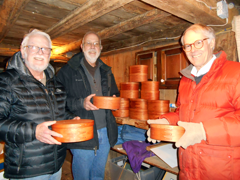 From left: Volunteers Mike Stevens, Bill Thomas, and Bob Ives show the first Shaker-inspired oval boxes.