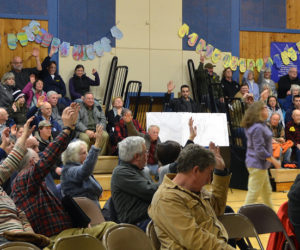 More than three-fourths of the audience votes in favor of repairs to the Bristol Mills Dam and improvements to the fish ladder in a straw poll at the close of a public hearing the evening of Tuesday, Jan. 30. (Maia Zewert photo)