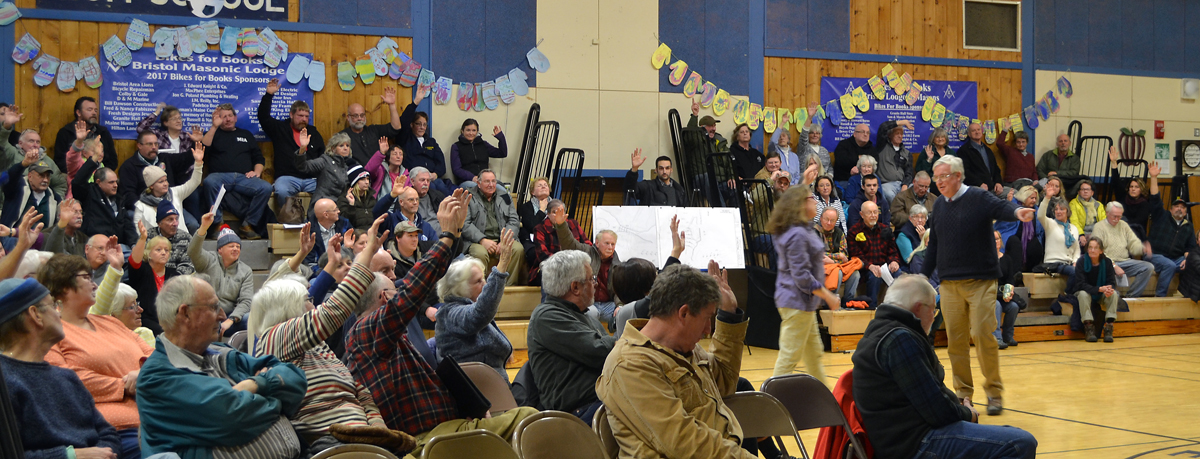 More than three-fourths of the audience votes in favor of repairs to the Bristol Mills Dam and improvements to the fish ladder in a straw poll at the close of a public hearing the evening of Tuesday, Jan. 30. (Maia Zewert photo)