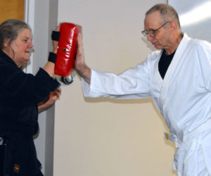 Danny Kelly performs a palm strike with instructor Linda Porter during a karate class at the Mobius community center in Damariscotta on Thursday, Dec. 21. (Matthew Mitterhoff photo)