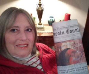 Sandee Brackett holds a copy of the Nov. 30 edition of The Lincoln County News with her photo on the front page. The photo won the November contest before going on to take the annual contest too. (Photo courtesy Sandee Brackett)