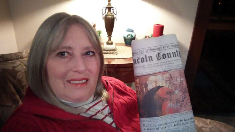 Sandee Brackett holds a copy of the Nov. 30 edition of The Lincoln County News with her photo on the front page. The photo won the November contest before going on to take the annual contest too. (Photo courtesy Sandee Brackett)