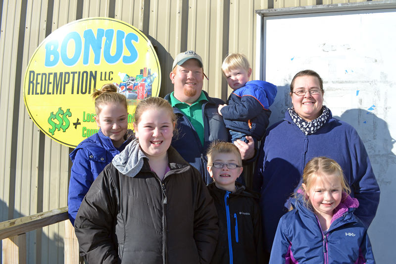 The Stevens family recently purchased Bonus Redemption LLC, which operates redemption centers in Damariscotta and Newcastle. From left: Elle , Emme, Casey, Nelsen, Reuben, Erica, and Brayelyne Stevens. (Maia Zewert photo)