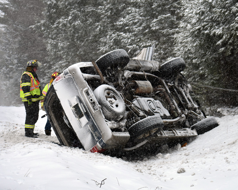 Waldoboro firefighters work at the scene of a rollover on Route 1. Emergency responders extricated two of the vehicle's four occupants. (Alexander Violo photo)