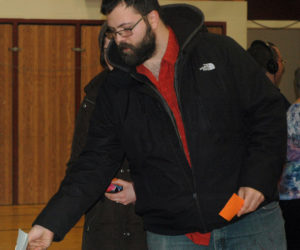 Noah Rosen casts his ballot during a special town meeting at Miller School in Waldoboro on Saturday, Jan. 6. Voters approved a moratorium on recreational-marijuana businesses. (Alexander Violo photo)