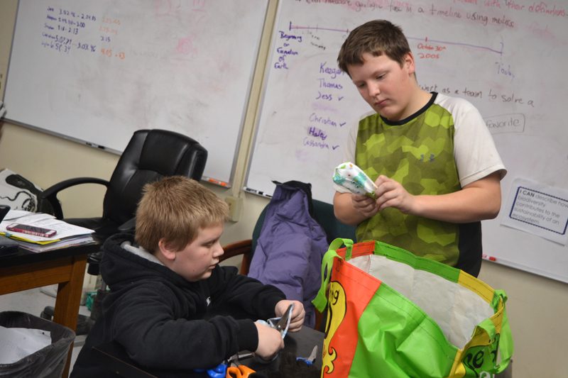 Whitefield Elementary School seventh-graders Bryce Lincoln (left) and Tyler Margitan trim sewn cloth hearts and turn them right-side out during the Whitefield National Junior Honor Society's Preemie Project event after school Friday, Jan. 19. (Christine LaPado-Breglia photo)