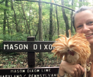 Heather Bolint and Mason the rooster at the Mason-Dixon line on the Appalachian Trail. (Photo courtesy Heather Bolint)