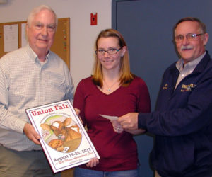 From left: George Gross, Union Fair -- Maine Wild Blueberry Festival poster committee chair, holds the 2017 Union Fair poster while poster winner Alyssa Willey, of Warren, accepts a $500 check from Union Fair -- Maine Wild Blueberry Festival President Ron Hawes for her winning design. (Photo courtesy John Jensen)