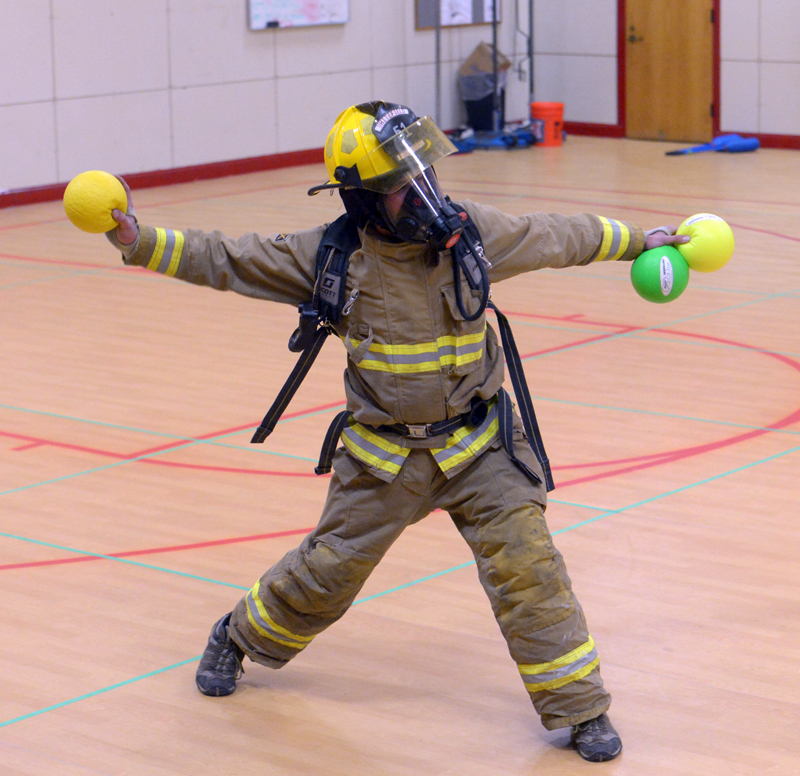 Whitefield fireman Jesse Barton blocks one ball while throwing another during a dodgeball training session. (Paula Roberts photo)