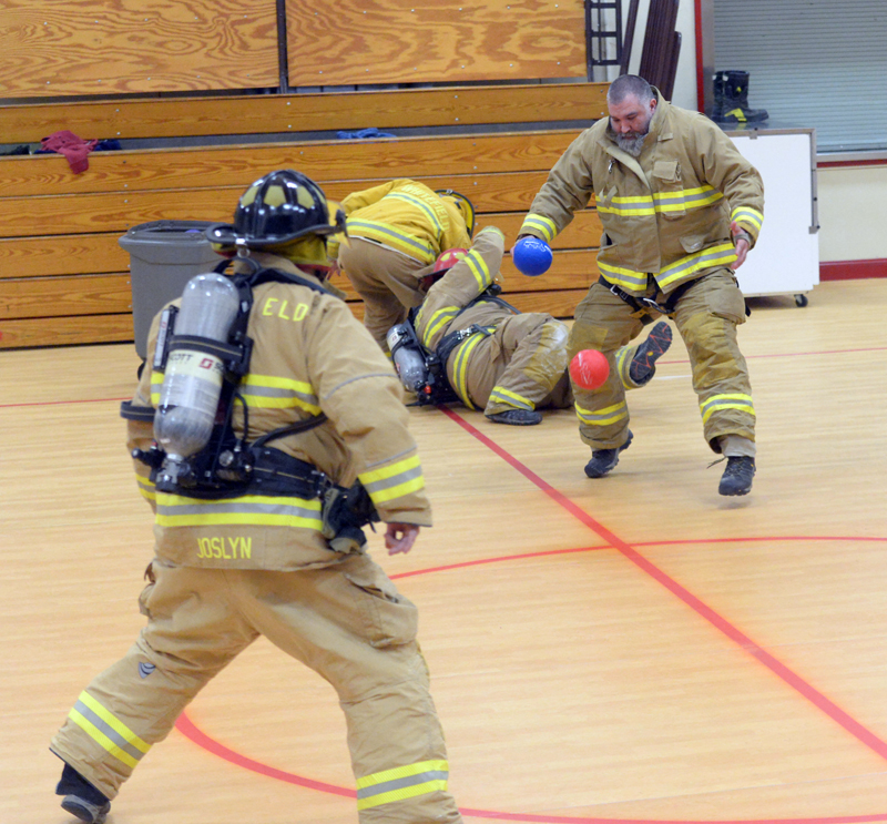 Whitefield fireman Garrett Joslyn throws a ball at Josh Moores as Louis Sell and Brian Ross wrestle over a loose ball. (Paula Roberts photo)