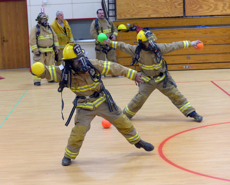 Ken Ripley and Garrett Joslyn throw in unison during a Whitefield Fire Department Scott Air Pack training exercise on Monday. (Paula Roberts photo)