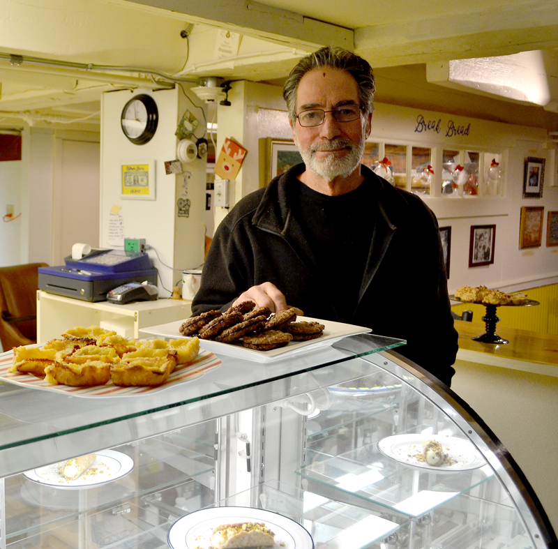 Bernie DeLisle stands behind the display counter at Osteria Bucci, his new eatery in the downtown Damariscotta space formerly home to Paco's Tacos. (Maia Zewert photo)