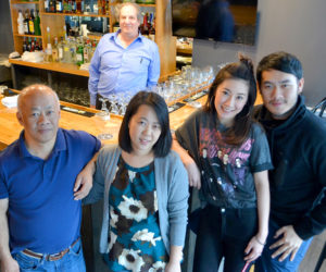 O-Cha owner Pongsakorn Hanjitsuwan (right) celebrates the opening of the Thai-insipred bar and grill with his family and the restaurant's general manager, Jason Simonds (back). From left: Chanint Hanjitsuwan, Simonds, Thanyalak Rojpanichkul, Samatchaya Limvathanalert, and Hanjitsuwan. (Maia Zewert photo)