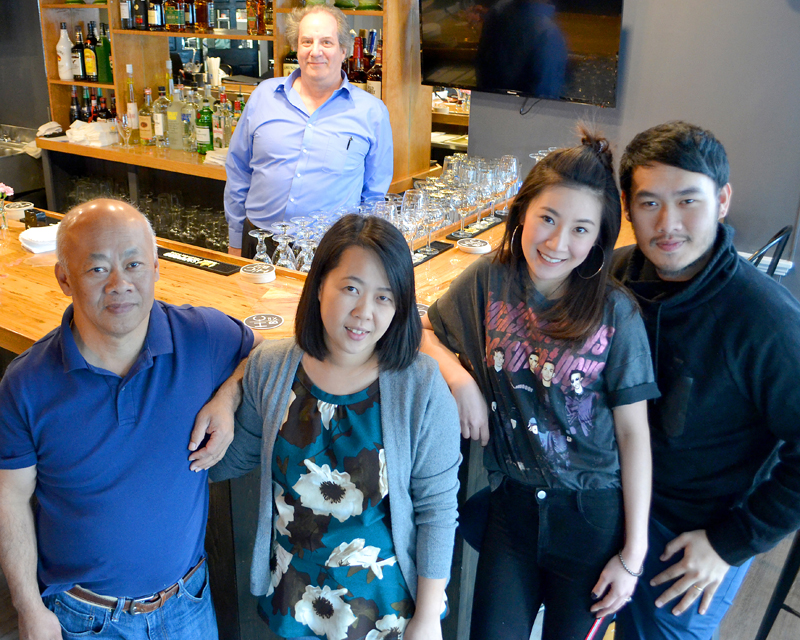 O-Cha owner Pongsakorn Hanjitsuwan (right) celebrates the opening of the Thai-insipred bar and grill with his family and the restaurant's general manager, Jason Simonds (back). From left: Chanint Hanjitsuwan, Simonds, Thanyalak Rojpanichkul,  Samatchaya Limvathanalert, and Hanjitsuwan. (Maia Zewert photo)