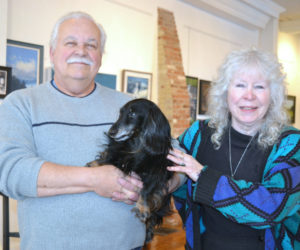 Wolfgang Busse and Polly McGrory pose with Max the gallery dog at McGrory & Wolf Gallery in downtown Waldoboro on Thursday, Feb. 1. (Christine LaPado-Breglia photo)