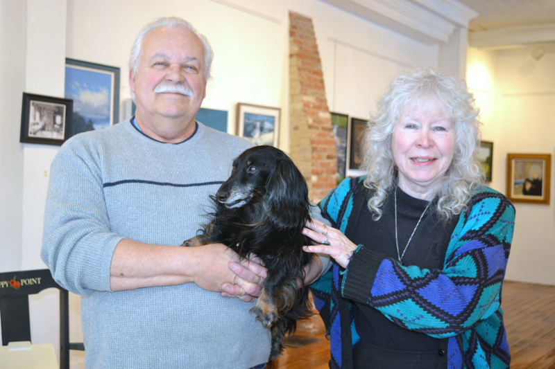 Wolfgang Busse and Polly McGrory pose with Max the gallery dog at McGrory & Wolf Gallery in downtown Waldoboro on Thursday, Feb. 1. (Christine LaPado-Breglia photo)