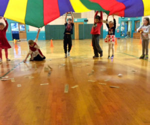Students play a parachute game in the gym Feb. 14 in celebration of 100 Day at Nobleboro Central School. They spent the morning circulating throughout the school playing counting games and doing hands-on activities.
