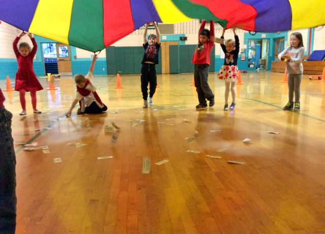 Students play a parachute game in the gym Feb. 14 in celebration of 100 Day at Nobleboro Central School. They spent the morning circulating throughout the school playing counting games and doing hands-on activities.