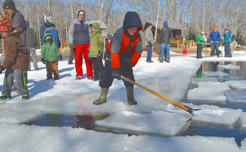 Lincoln Ball uses an antique hand tool to guide a block of ice during the ice harvest at the Thompson Ice House in South Bristol on March 12, 2017. The 2018 event is scheduled for Sunday, Feb. 18. (Maia Zewert photo)