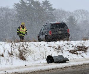 A Waldoboro firefighter at the scene of a rollover on Route 220 the morning of Sunday, Feb. 4. (Alexander Violo photo)