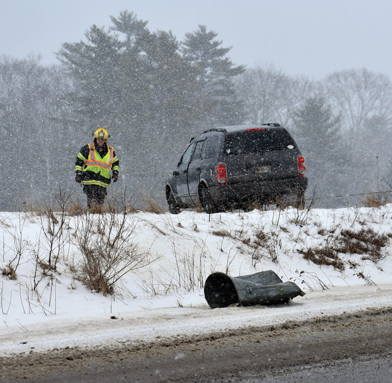 A Waldoboro firefighter at the scene of a rollover on Route 220 the morning of Sunday, Feb. 4. (Alexander Violo photo)