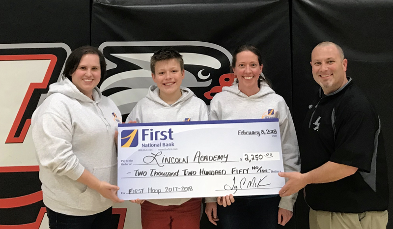 Lincoln Academy in Newcastle receives a donation through First National Bank's First Hoop program.