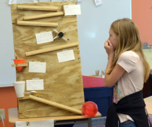 Kayle Lappin holds her breath as she waits to see if her machine will pop a balloon. (Paula Roberts photo)