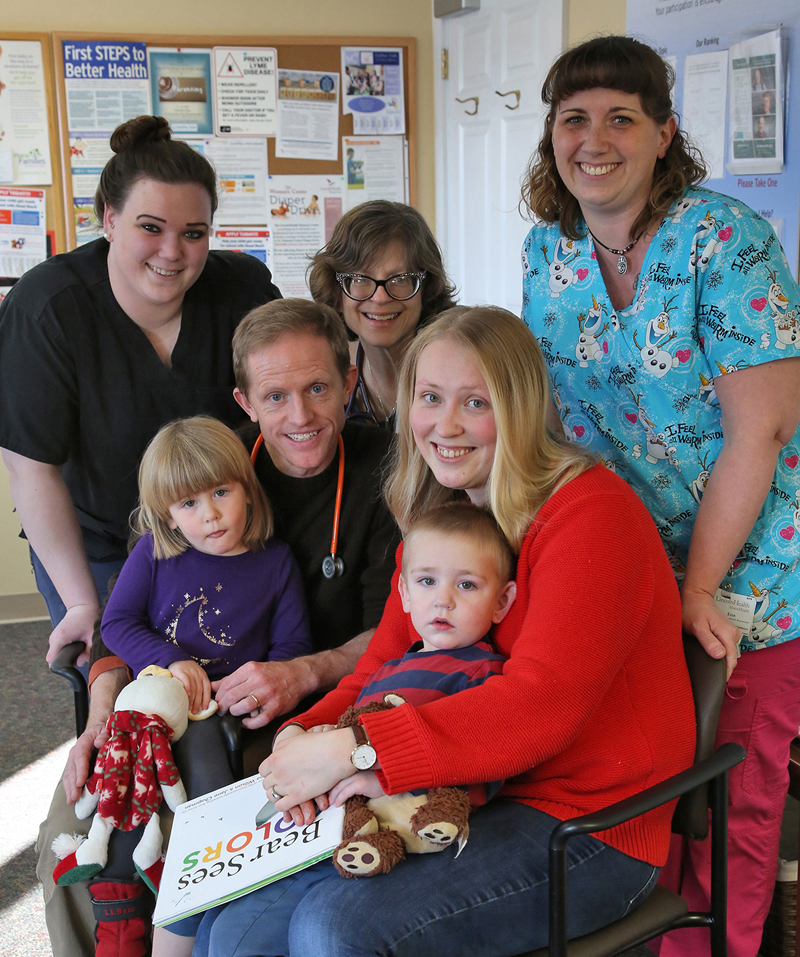 Lincoln Medical Partners Damariscotta physicians and medical assistants gave the office's 20,000th free book to two-year-old Lev Martin while he was at the Damariscotta pediatrics practice for a well child visit with his mom and sister. Pictures are (back) Kara Dow, Dr. Joann Kaplan, and Erin Smith, and (front) Anastasia Martin, Dr. Andy Russ, Ekaterina Martin, and Lev Martin.