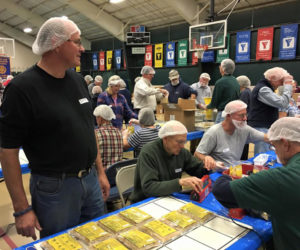 Volunnteers pack food at last year's Rotary-Lions nonperishable food pack.