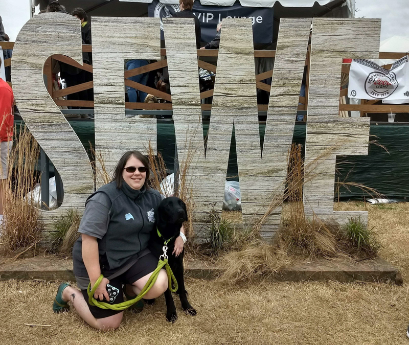 Erin Bailey and Casco pose at the Southeastern Wildlife Exposition in Charleston, South Carolina. (Photo courtesy Jessica Bailey)