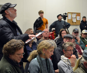 Alna resident Ray Robitaille asks a question about Ed Pentaleri's presentation during a public hearing about the upcoming school choice referendum at the Alna fire station Monday, March 5. (Maia Zewert photo)