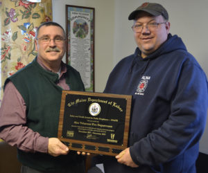 Alna Fire Chief Mike Trask (right) accepts the Safety and Health Award for Public Employers from Michael LaPlante, of the Maine Department of Labor, during the Alna Board of Selectman's meeting Wednesday, March 14. (Maia Zewert photo)