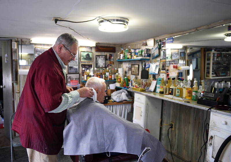 Bruce Soule cuts George Sawtelle's hair at his barbershop in downtown Damariscotta on Thursday, March 15. (Jessica Picard photo)