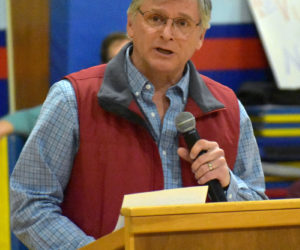 Lincoln County Democratic Committee Chair Chris Johnson welcomes voters to a caucus at Great Salt Bay Community School in Damariscotta on Sunday, March 4. (Alexander Violo photo)