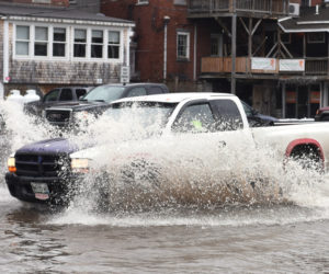 A truck drives through floodwaters in the municipal parking lot in downtown Damariscotta on Friday, March 2. (Jessica Picard photo)