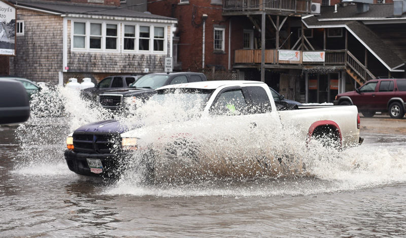 A truck drives through floodwaters in the municipal parking lot in downtown Damariscotta on Friday, March 2. (Jessica Picard photo)