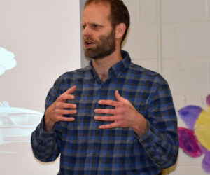 Garret Martin, of Newcastle, presents the results of AOS 93's survey about Lincoln Academy during a meeting at Great Salt Bay Community School in Damariscotta on Thursday, March 15. (Alexander Violo photo)