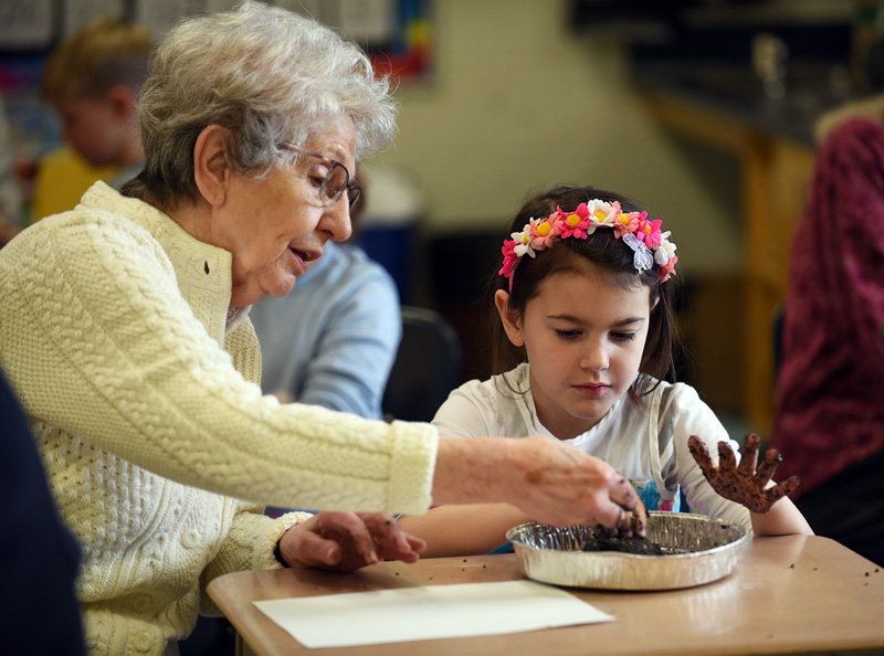 Roberta Atkinson and 8-year-old Rosy Kate Adams make seed balls during a Miles of Friends event at Great Salt Bay Community School in Damariscotta on Wednesday, March 21. (Jessica Picard photo)